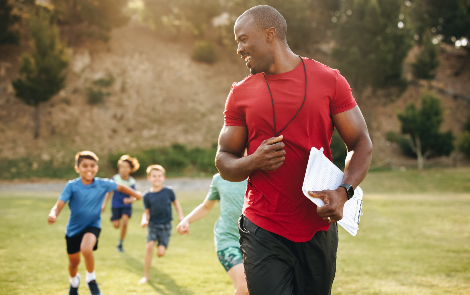 Sports trainer coaching elementary school children